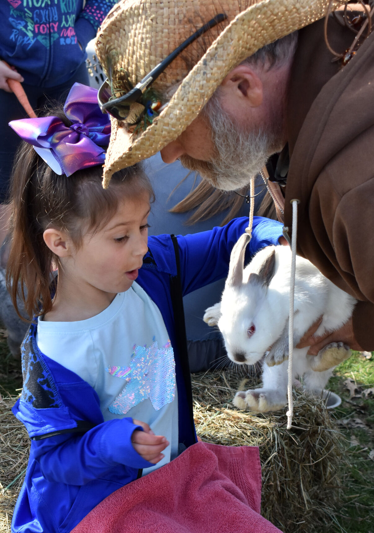 Addie Haas reaches for a bunny